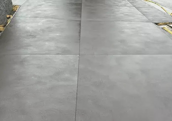 Smooth grey concrete panels divided by cut joints