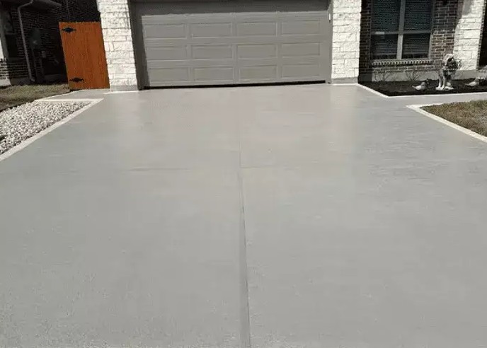 Concrete driveway leading to a residential garage door