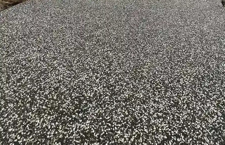 Exposed aggregate driveway with a curved edge